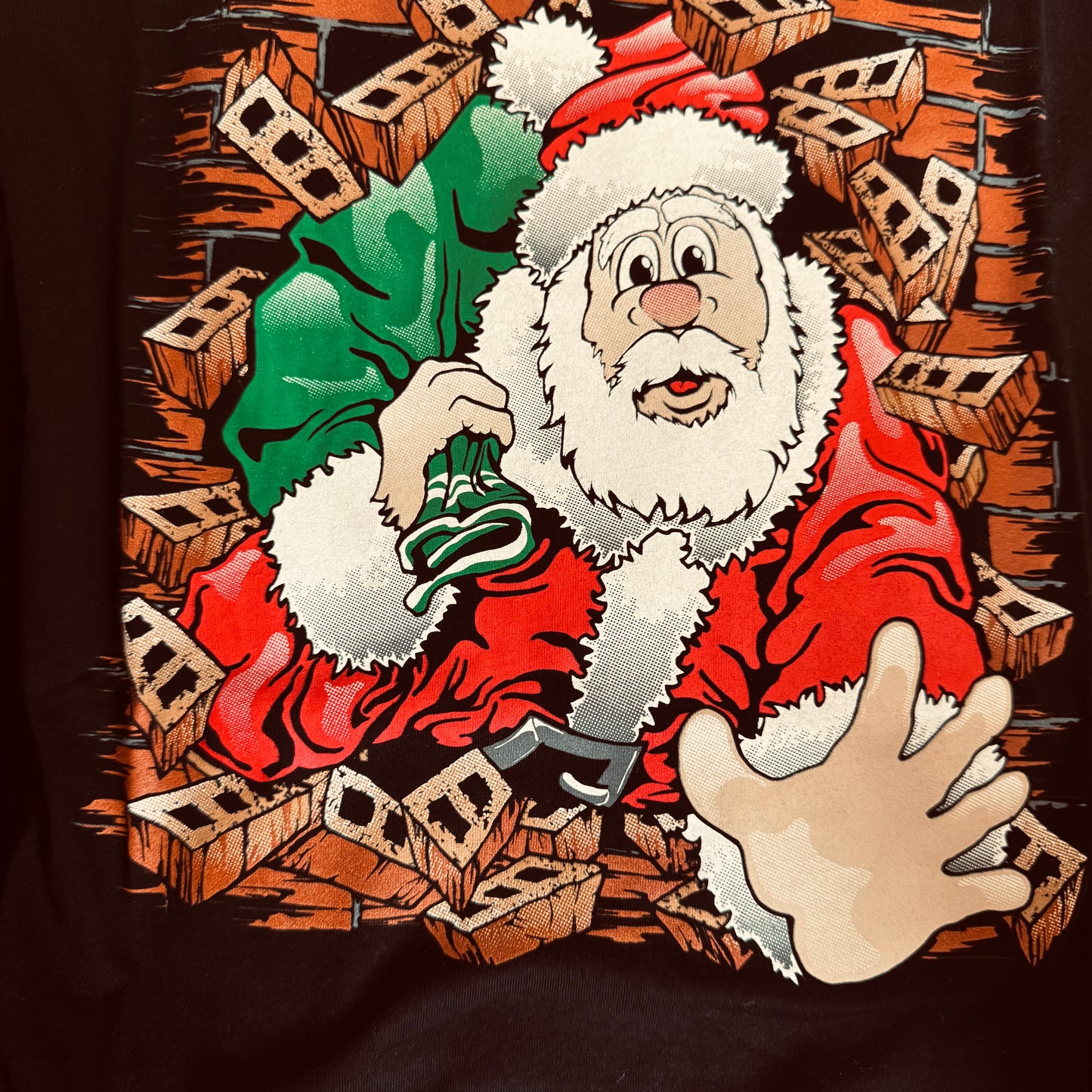 Santa busting through the front and back of the shirt