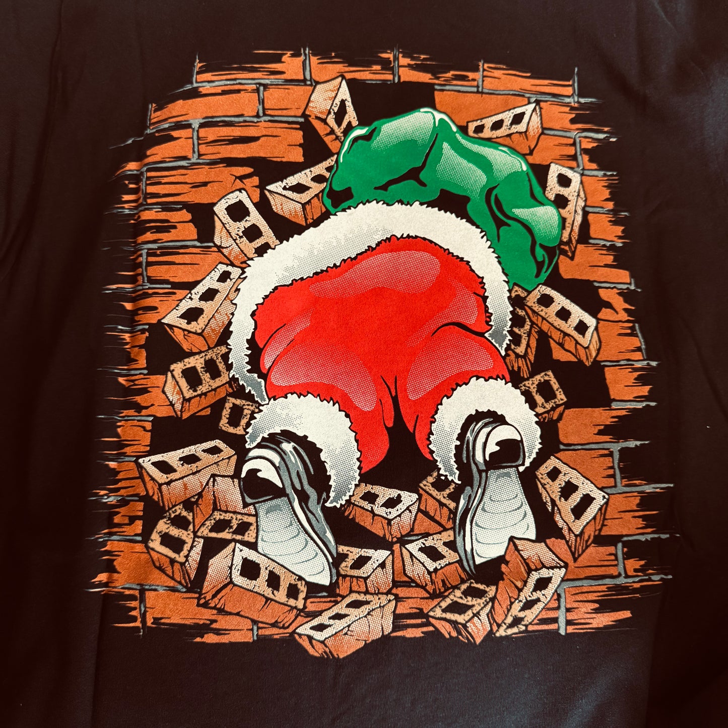 Santa busting through the front and back of the shirt